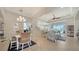 Spacious living room with tile floors, elegant furniture, dining area, and water view out the windows at 4220 Miriana Way, Sarasota, FL 34233
