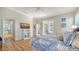 Bright main bedroom with wood floors, TV and access to patio at 4220 Miriana Way, Sarasota, FL 34233