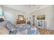 Comfortable main bedroom with a tropical-themed decor, hardwood floors, and a well-lit setting at 4220 Miriana Way, Sarasota, FL 34233