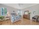 Relaxing main bedroom with a tropical-themed decor, wood floors, ceiling fan, and natural light at 4220 Miriana Way, Sarasota, FL 34233