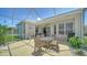 The outdoor patio space is screened and has a table with seating and heater at 4220 Miriana Way, Sarasota, FL 34233
