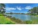 Scenic view of the community pond and surrounding homes on a sunny day at 4220 Miriana Way, Sarasota, FL 34233