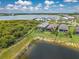 Lovely aerial view of the home showcasing the backyard screened pool, mature trees, and a serene pond at 42250 Ramble Rd, Punta Gorda, FL 33982