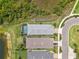 Bird's eye view of the property featuring a screened-in pool, lake view, and neatly landscaped surroundings at 42250 Ramble Rd, Punta Gorda, FL 33982