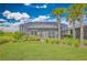 A beautiful backyard view with a screened pool, well-maintained lawn, and tropical landscaping at 42250 Ramble Rd, Punta Gorda, FL 33982