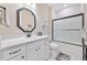 Bathroom with a white vanity, framed mirror, and a shower featuring a frosted glass door at 42250 Ramble Rd, Punta Gorda, FL 33982