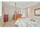 Tastefully decorated bedroom with comfortable bed, natural light, and connecting bathroom at 42250 Ramble Rd, Punta Gorda, FL 33982