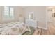 Bright bedroom featuring a tropical style bed, wicker furniture, decorative rug, and a shuttered window at 42250 Ramble Rd, Punta Gorda, FL 33982