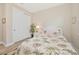 Comfortable bedroom with tropical style bed, wicker nightstand, and closet providing a cozy retreat at 42250 Ramble Rd, Punta Gorda, FL 33982
