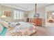 Inviting primary bedroom with a four poster bed, natural light, and functional bedside tables at 42250 Ramble Rd, Punta Gorda, FL 33982