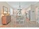 Cozy dining area with chandelier lighting, rustic furniture, and easy access to the kitchen and the rest of the house at 42250 Ramble Rd, Punta Gorda, FL 33982