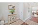 Entryway with compass decor and a hallway leading to a living area with wood flooring at 42250 Ramble Rd, Punta Gorda, FL 33982