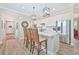 Modern kitchen featuring white cabinetry, a kitchen island with bar stools, and stainless steel appliances at 42250 Ramble Rd, Punta Gorda, FL 33982