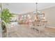Open-concept living and dining area with light wood floors and stylish, neutral decor at 42250 Ramble Rd, Punta Gorda, FL 33982
