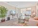 Bright living room featuring wood floors, a comfortable sofa, a decorative rug, and views of the outdoor screened in porch at 42250 Ramble Rd, Punta Gorda, FL 33982