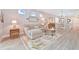 Spacious living room showcases comfortable seating, decorative rug, and view into the kitchen and dining area at 42250 Ramble Rd, Punta Gorda, FL 33982