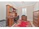 Inviting home office with a large wooden desk, built-in storage, and a bright window providing natural light at 42250 Ramble Rd, Punta Gorda, FL 33982