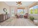 Relaxing outdoor patio with comfortable seating, ceiling fan, and views of the pool and backyard at 42250 Ramble Rd, Punta Gorda, FL 33982