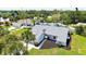Aerial view of single-story home with a two-car garage, showcasing its manicured landscaping and serene neighborhood setting at 4308 Kingston Loop, Sarasota, FL 34238