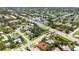 Aerial shot of home in residential area near parks and roadways, blending urban and natural settings at 4308 Kingston Loop, Sarasota, FL 34238