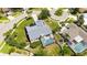 An aerial view of a home with a screened-in pool, grey roof and well-maintained landscaping in a residential neighborhood at 4308 Kingston Loop, Sarasota, FL 34238