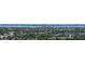 Scenic aerial view of homes and lush greenery, bordering the tranquil ocean waters in the distance at 4308 Kingston Loop, Sarasota, FL 34238