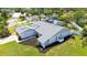 A nice aerial view of a lovely home with lush green grass, beautiful palm trees, and a well-maintained roof at 4308 Kingston Loop, Sarasota, FL 34238