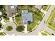 An aerial view displays a beautiful home in a manicured cul-de-sac with mature landscaping and pool in the backyard at 4308 Kingston Loop, Sarasota, FL 34238