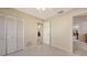 Bedroom featuring tile floors, closet with louvered doors, and interior entry door at 4308 Kingston Loop, Sarasota, FL 34238