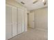 Bedroom featuring tile floors, closet with louvered doors, and interior entry door at 4308 Kingston Loop, Sarasota, FL 34238
