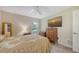 Comfortable bedroom featuring a ceiling fan, mounted television and ample natural light from the window at 4308 Kingston Loop, Sarasota, FL 34238