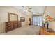 A bright bedroom featuring a ceiling fan, and large dresser at 4308 Kingston Loop, Sarasota, FL 34238