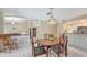 Dining room featuring a wood table, vintage light fixture, and view into the living room at 4308 Kingston Loop, Sarasota, FL 34238