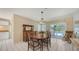 Dining room featuring a wood table, vintage light fixture, and sliding glass doors to the pool at 4308 Kingston Loop, Sarasota, FL 34238