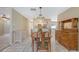 Open dining area with a table, chairs, and an antique cabinet adjacent to the kitchen at 4308 Kingston Loop, Sarasota, FL 34238