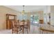 Dining room featuring a wood table, vintage light fixture, and sliding glass doors to the pool at 4308 Kingston Loop, Sarasota, FL 34238