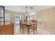 Dining room featuring a wood table, vintage light fixture, and sliding glass doors to the pool at 4308 Kingston Loop, Sarasota, FL 34238