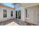 Inviting front entrance with decorative door, sidelights, and tiled patio at 4308 Kingston Loop, Sarasota, FL 34238