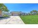Lovely single-Gathering home with a two-car garage, lush green lawn, and meticulously maintained landscaping at 4308 Kingston Loop, Sarasota, FL 34238