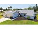 Charming home featuring a well-kept lawn, mature palm trees, a two-car garage, and a landscaped front yard at 4308 Kingston Loop, Sarasota, FL 34238
