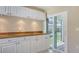 Bright kitchen area with white cabinets, granite countertops, and tile flooring at 4308 Kingston Loop, Sarasota, FL 34238
