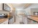 Modern kitchen featuring stainless steel appliances, granite counters, and ample cabinet space at 4308 Kingston Loop, Sarasota, FL 34238