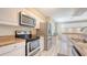 Bright kitchen with stainless steel appliances, granite countertops, and white cabinets at 4308 Kingston Loop, Sarasota, FL 34238