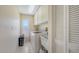 Bright laundry room equipped with washer, dryer, utility sink and storage at 4308 Kingston Loop, Sarasota, FL 34238