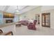 Comfortable living room features fireplace, TV, elegant lighting, and views into other rooms at 4308 Kingston Loop, Sarasota, FL 34238
