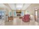 Bright living room with tile flooring, fireplace, and comfortable seating; perfect for relaxation and entertaining at 4308 Kingston Loop, Sarasota, FL 34238