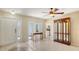 Bright living room featuring tile flooring, a front door view, and a dining room peek at 4308 Kingston Loop, Sarasota, FL 34238