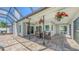 Covered patio with ceiling fans and a dining set overlooking the screened-in pool at 4308 Kingston Loop, Sarasota, FL 34238