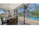 Covered patio featuring a ceiling fan and outdoor dining area with pool access at 4308 Kingston Loop, Sarasota, FL 34238