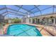 Lovely screened-in pool with a brick patio and cozy outdoor dining space at 4308 Kingston Loop, Sarasota, FL 34238